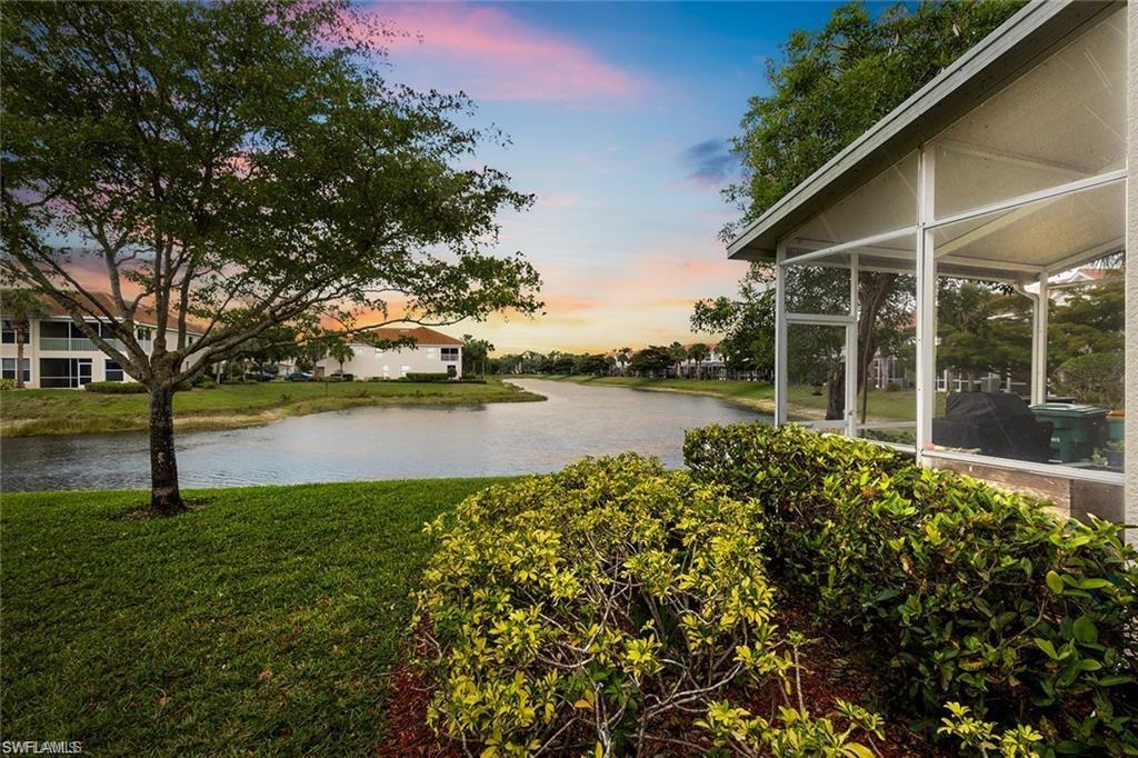 1390 Tiffany Lane, Unit 2302 Naples, FL 34105 - Photo 31 of 37 a view of a lake with a garden and trees