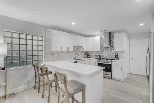 a kitchen with a table and chairs in it