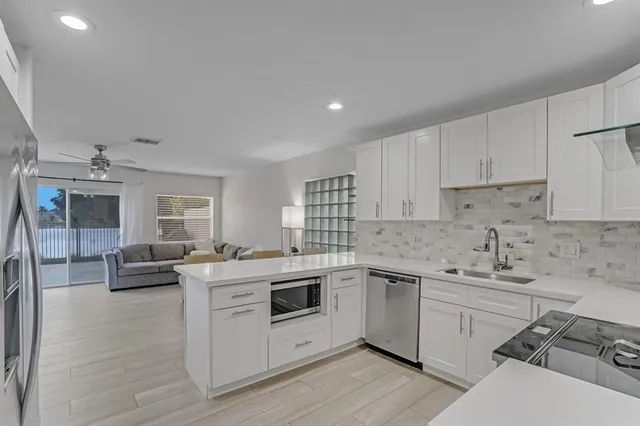 a kitchen that has a sink and a stove top oven