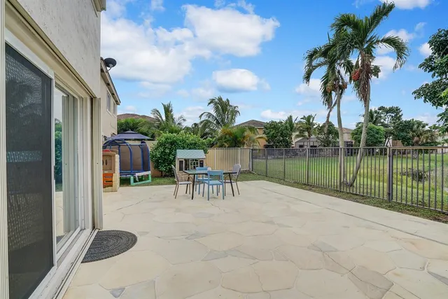 a view of a chair and table in the garden