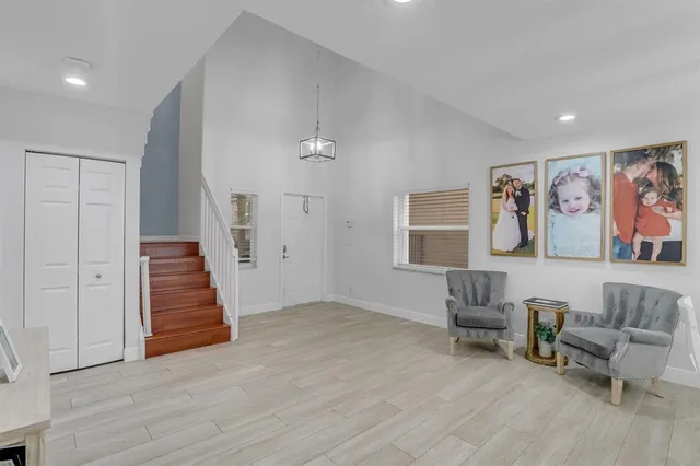 a view of a livingroom with furniture and staircase