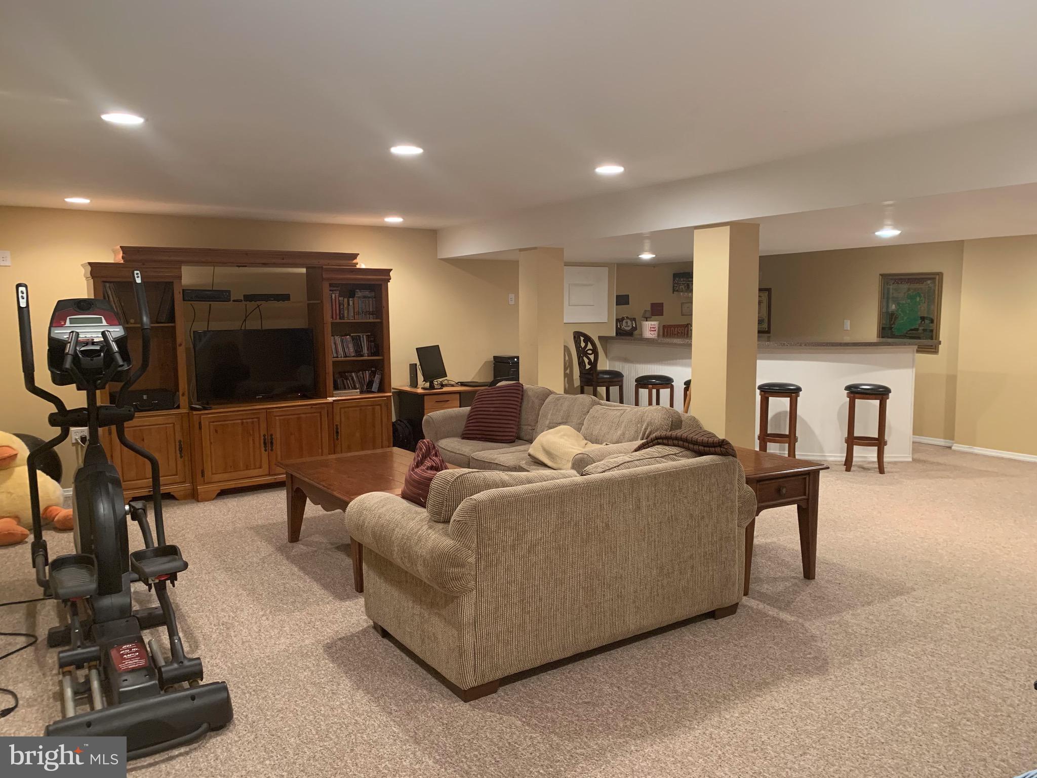 1292 Heller Drive Yardley, PA 19067 - Photo 32 of 36 a living room with furniture and a flat screen tv
