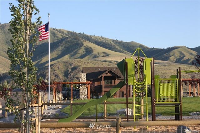 a view of house with yard and sitting area