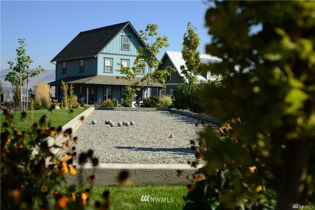 an aerial view of a houses with a big yard