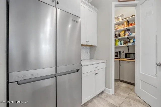 a large bedroom with a bed and wooden floor