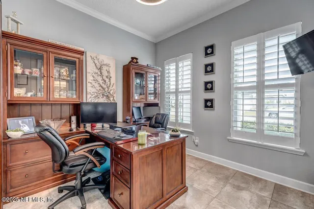 a bedroom with a bed a chandelier and next to a window