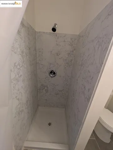 a kitchen with a refrigerator and a stove top oven