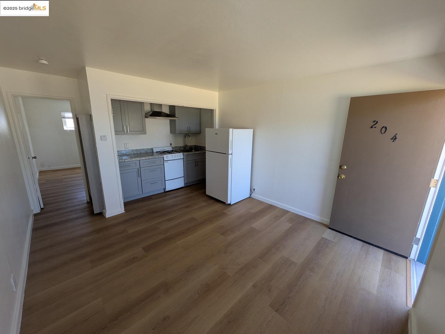 1213 San Pablo Avenue Berkeley, CA 94706 - Photo 3 of 13 a kitchen with a refrigerator and a stove top oven
