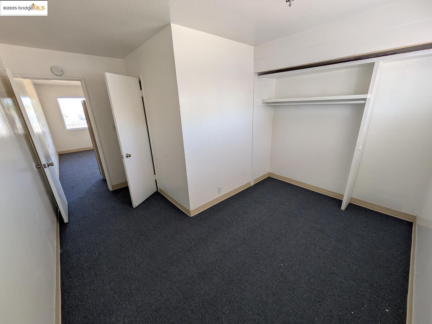 1213 San Pablo Avenue Berkeley, CA 94706 - Photo 6 of 13 a view of an empty room with wooden floor and a window