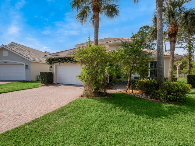 a house with palm tree in front of it