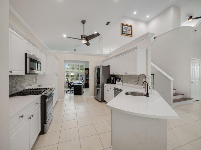 a kitchen with stainless steel appliances granite countertop a sink and cabinets