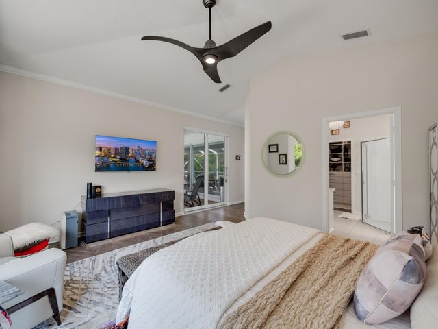 a bedroom with a bed and dresser with mirror