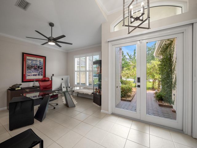 a living room with furniture and a floor to ceiling window