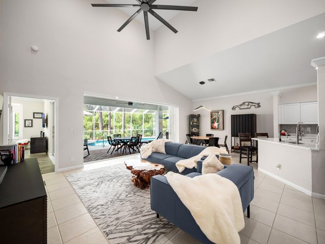 a living room with furniture fireplace and a large window