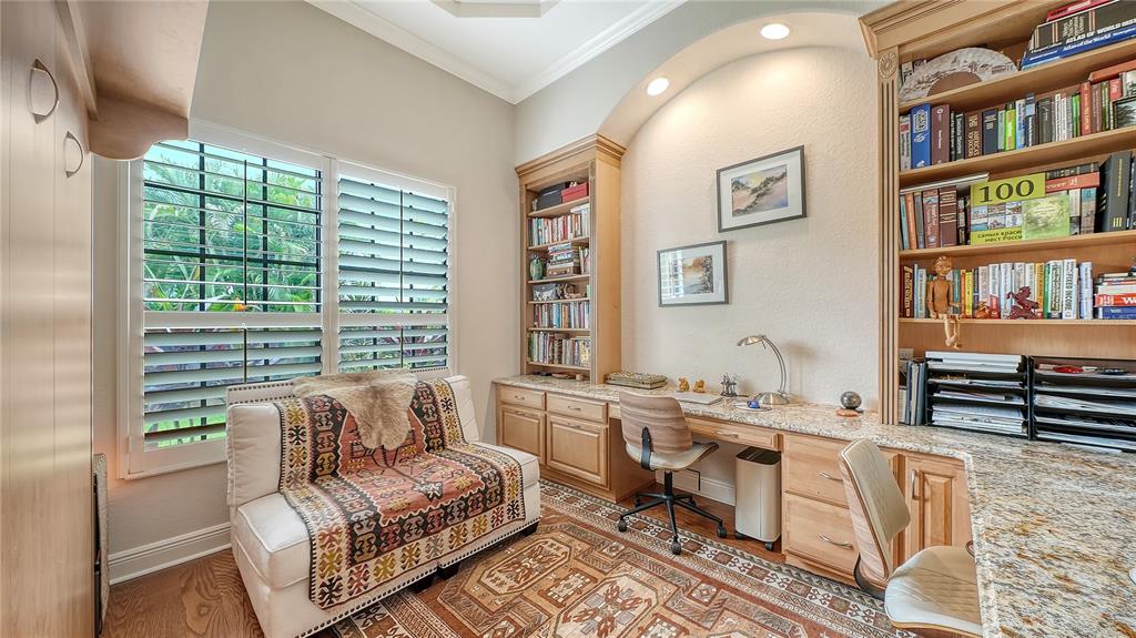1630 Assisi Drive, Unit 18 Sarasota, FL 34231 - Photo 18 of 42 a living room with furniture a bookshelf and a window