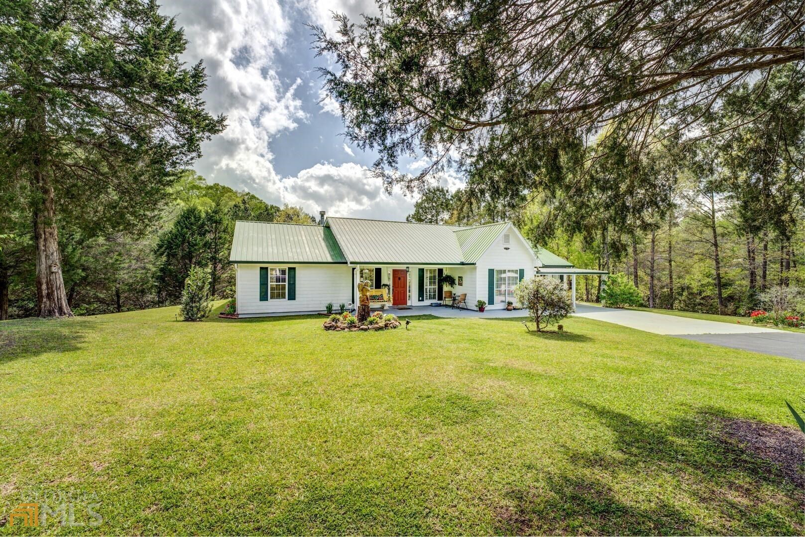 525 Cook Road Monticello, GA 31064 - Photo 1 of 1 a yellow house in middle of the forest