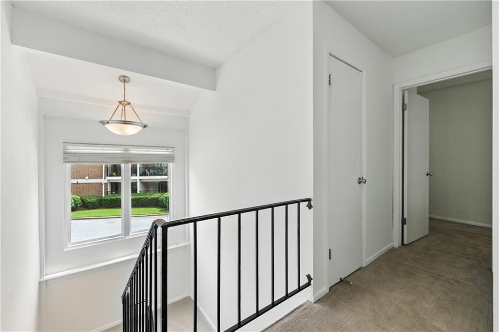 3301 Henderson Mill Road, Unit AA3 Atlanta, GA 30341 - Photo 17 of 32 a view of a hallway with windows and stairs