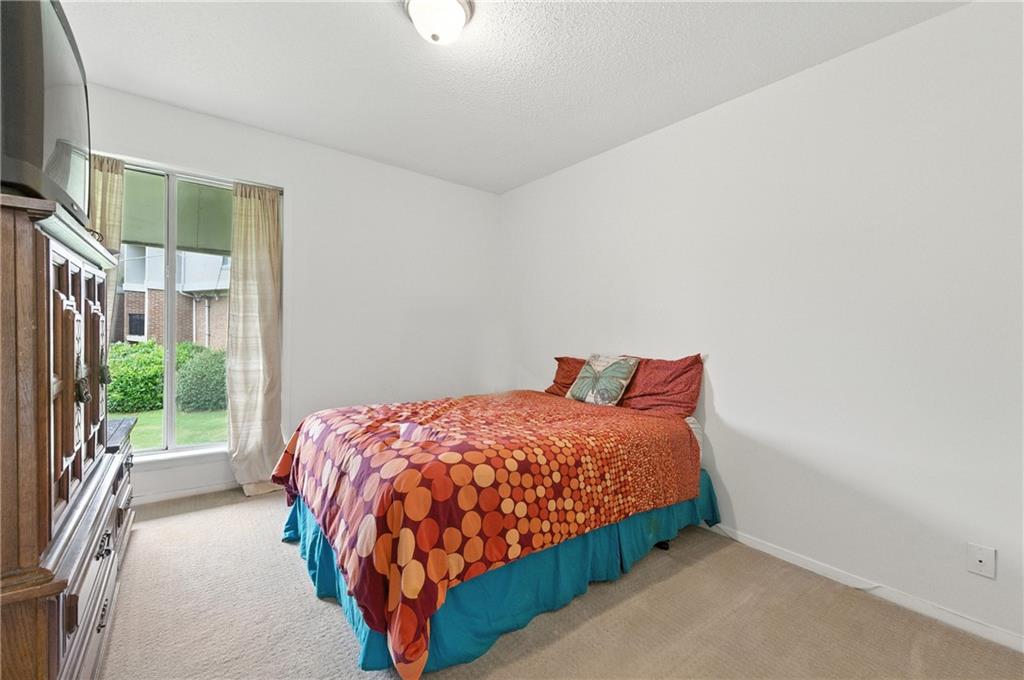 3301 Henderson Mill Road, Unit AA3 Atlanta, GA 30341 - Photo 20 of 32 a bedroom with a bed lamp and a large window