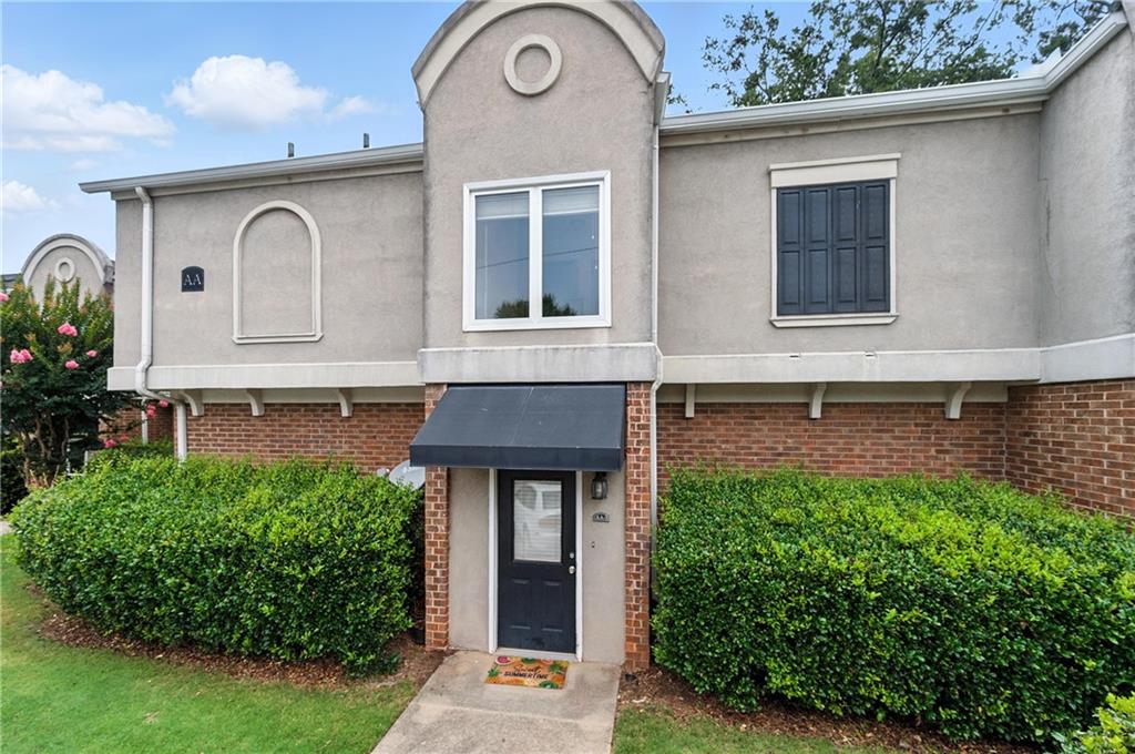 3301 Henderson Mill Road, Unit AA3 Atlanta, GA 30341 - Photo 2 of 32 a front view of a house with garden