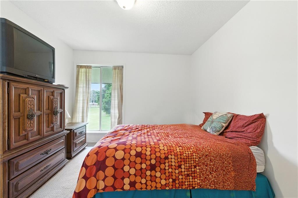 3301 Henderson Mill Road, Unit AA3 Atlanta, GA 30341 - Photo 21 of 32 a bedroom with a large window and flat screen tv