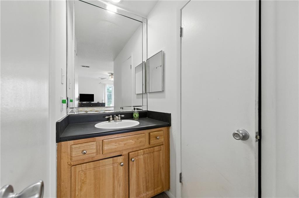 3301 Henderson Mill Road, Unit AA3 Atlanta, GA 30341 - Photo 26 of 32 a bathroom with a granite countertop sink and a mirror