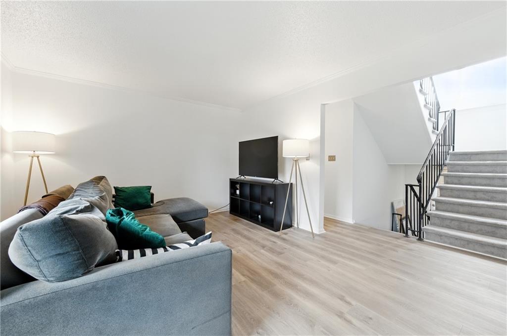 3301 Henderson Mill Road, Unit AA3 Atlanta, GA 30341 - Photo 3 of 32 a living room with furniture and a flat screen tv