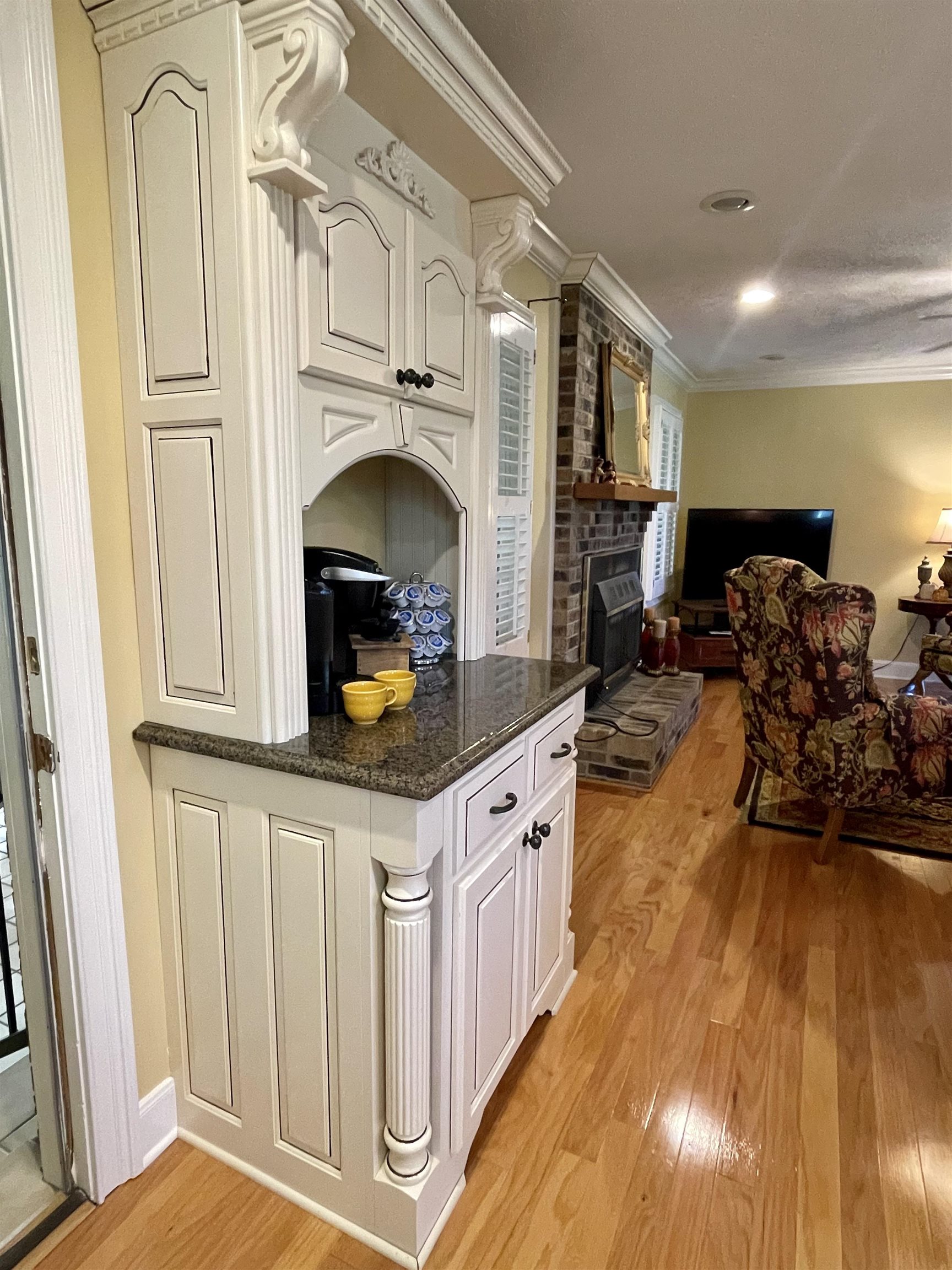 926 57th Highway Ramer, TN 38367 - Photo 9 of 25 a kitchen with stainless steel appliances granite countertop a stove a sink dishwasher and a fireplace with wooden floor