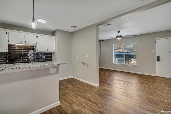 a kitchen with kitchen island a stove and a wooden floors