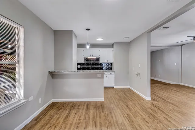 a view of kitchen with wooden floor and electronic appliances