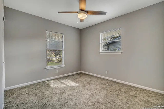 a view of room with window and ceiling fan