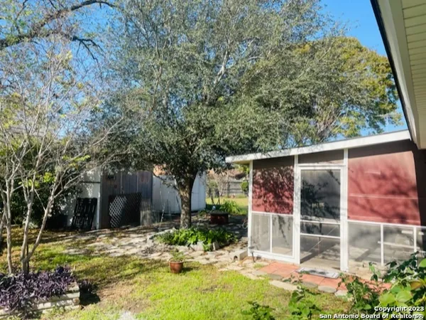 front view of a house with a tree