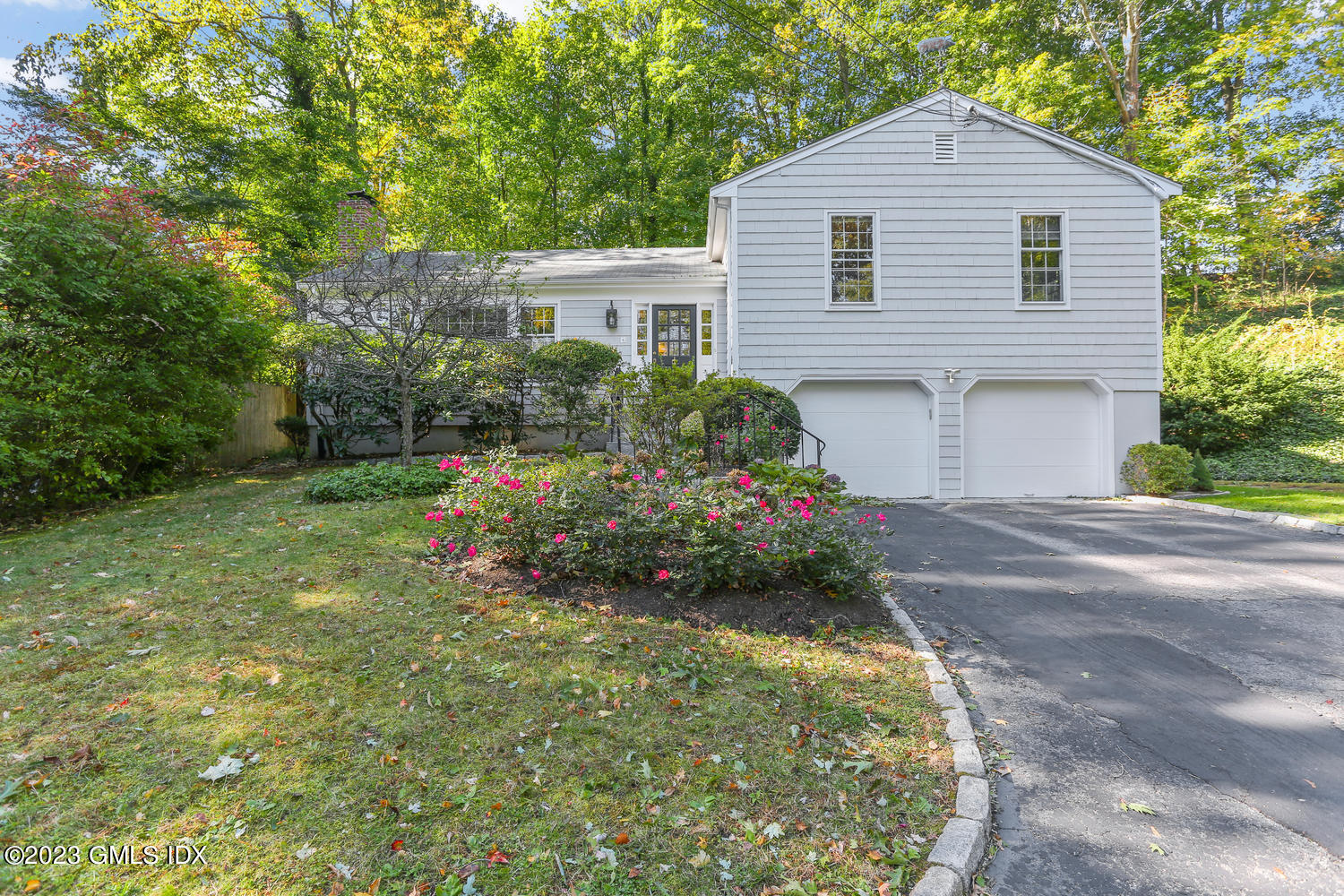 6 Pintail Lane Greenwich, CT 06830 - Photo 1 of 41 a front view of a house with a yard and garage