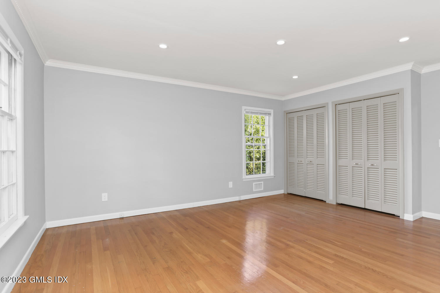 6 Pintail Lane Greenwich, CT 06830 - Photo 19 of 41 an empty room with wooden floor and windows