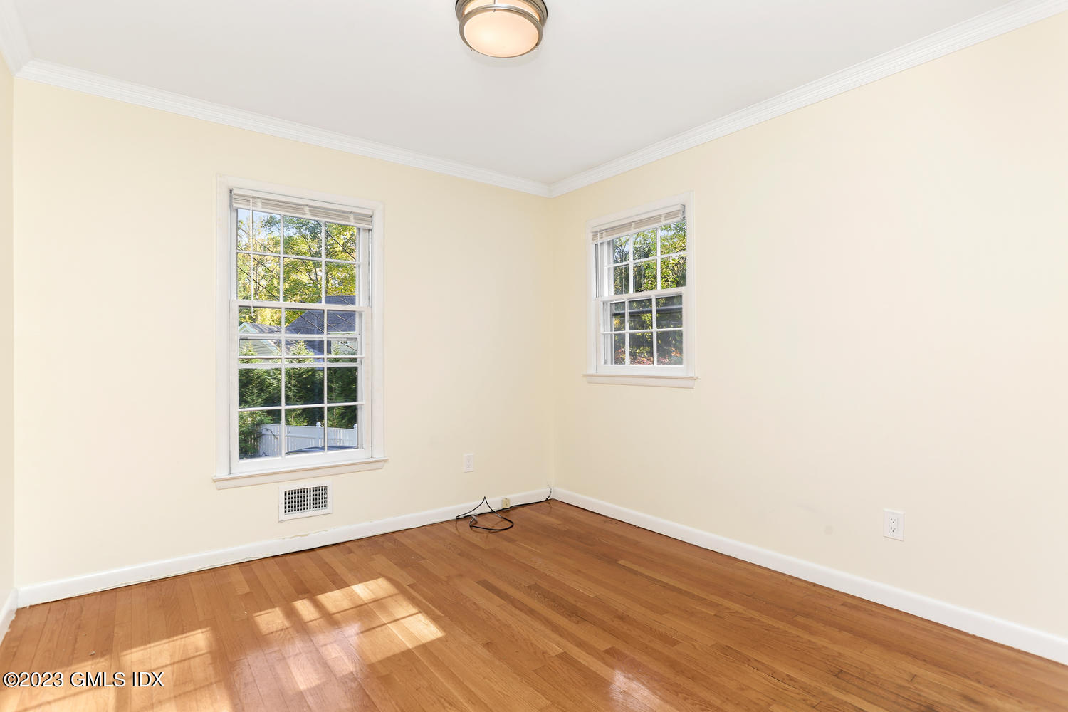 6 Pintail Lane Greenwich, CT 06830 - Photo 23 of 41 a view of an empty room with wooden floor and a window