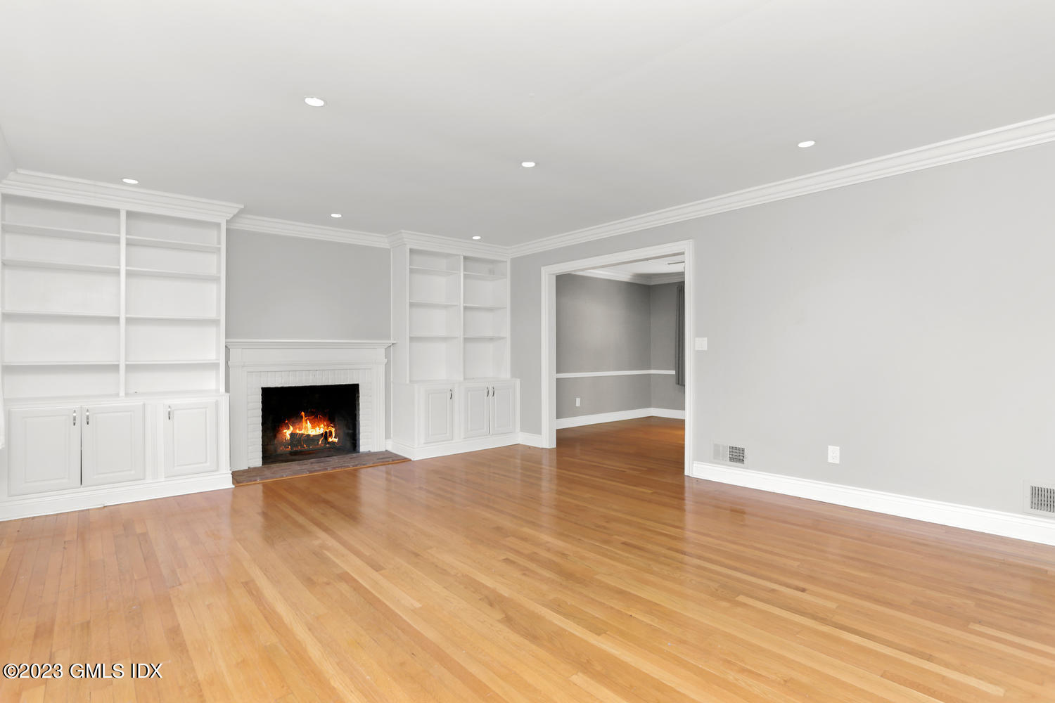 6 Pintail Lane Greenwich, CT 06830 - Photo 7 of 41 a view of an empty room with wooden floor fireplace and a window