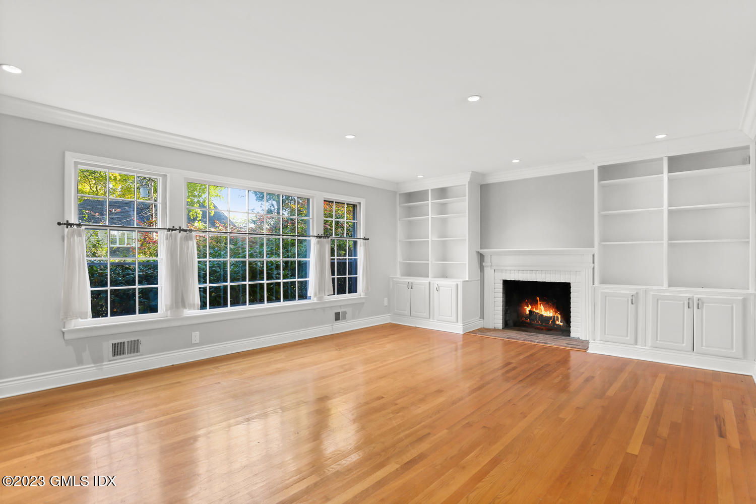 6 Pintail Lane Greenwich, CT 06830 - Photo 8 of 41 a view of an empty room with a fireplace and a window