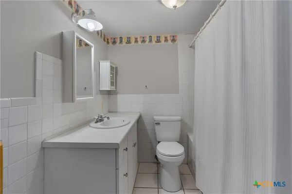 a bathroom with a sink toilet and vanity