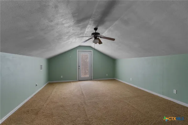 a view of empty room with ceiling fan