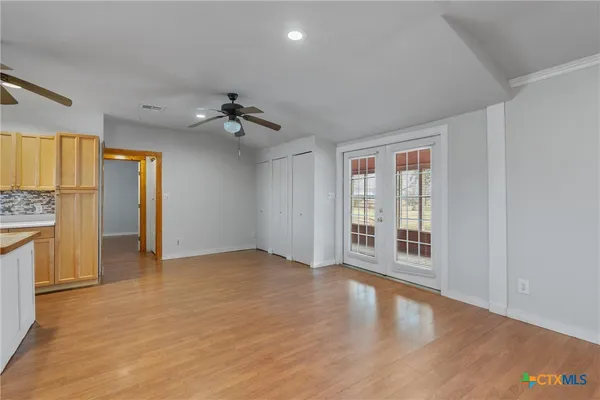 a view of an empty room with a fireplace and a window