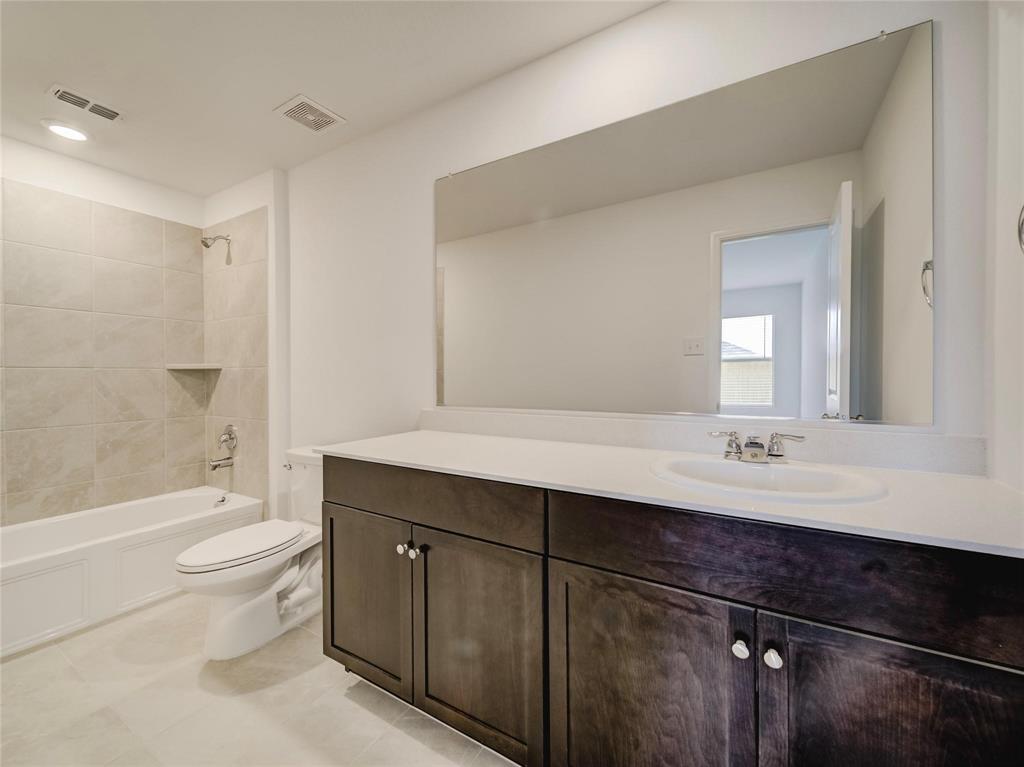 357 Sun Bluff Road Fort Worth, TX 76052 - Photo 12 of 35 Bathroom featuring a dark wood-finish vanity with a light countertop and integrated sink