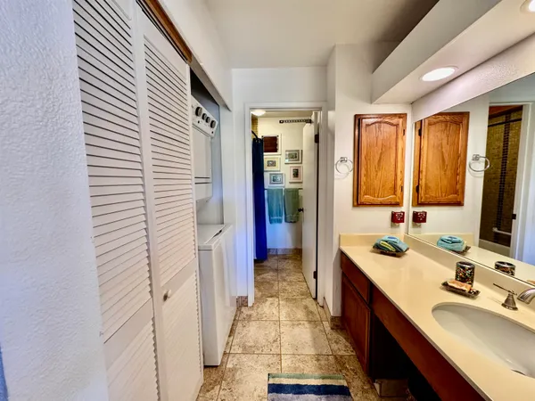 a bathroom with a sink a mirror and a shower