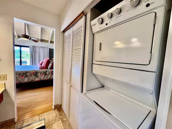 a view of a bedroom with a bed and a window