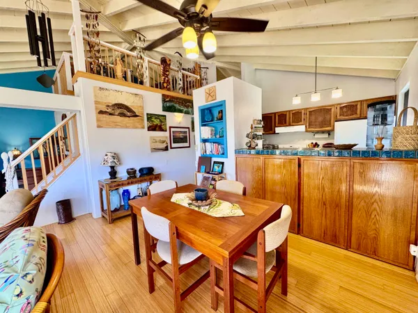 a dining room with furniture and wooden floor