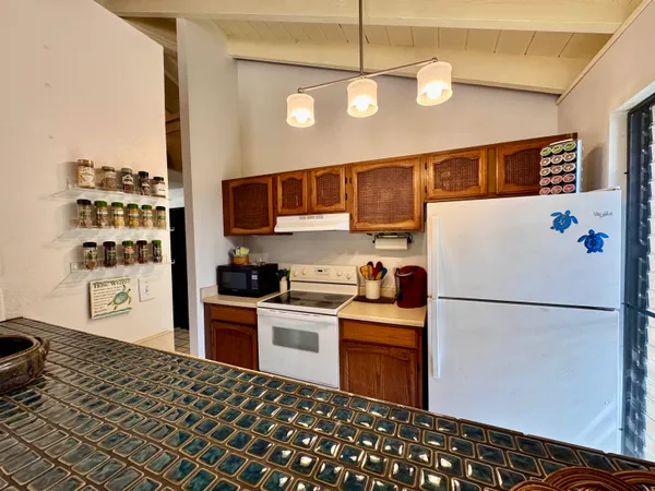 a kitchen with stainless steel appliances granite countertop a refrigerator a stove a sink and a refrigerator