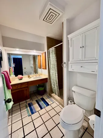 a room with two chairs and a table with projector screen