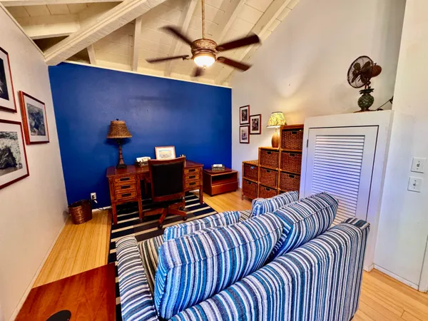a bedroom with furniture and a potted plant