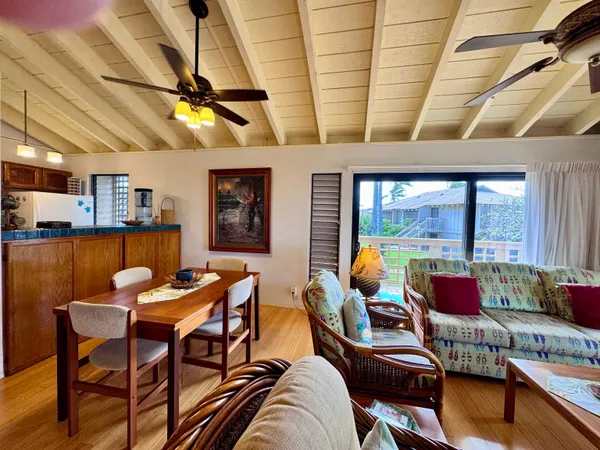 a dining room with furniture and a large window