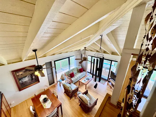 a living room with lots of furniture and wood floor