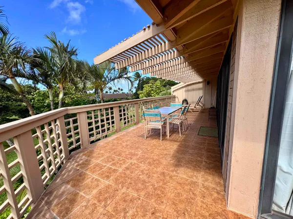 a view of a chairs and table in patio with wooden fence