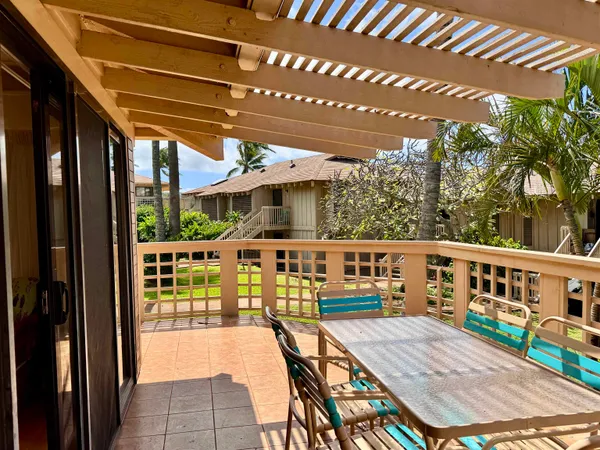 a view of a patio with dining table and chairs with wooden floor